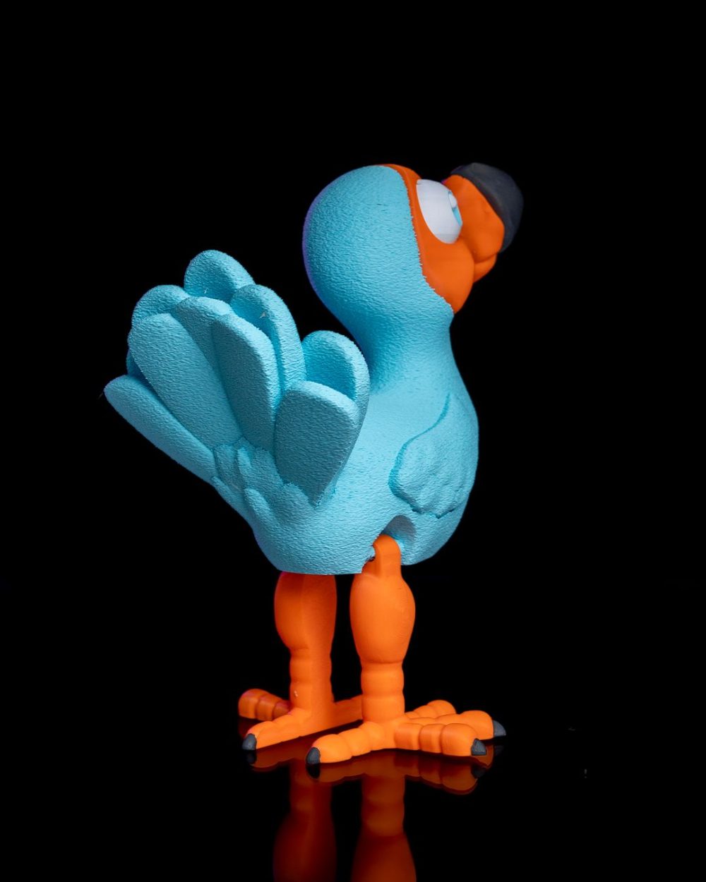 Articulated Dodo Bird – Custom – 3D Printed – Figure in blue and orange with a black hat, displayed on a black background.