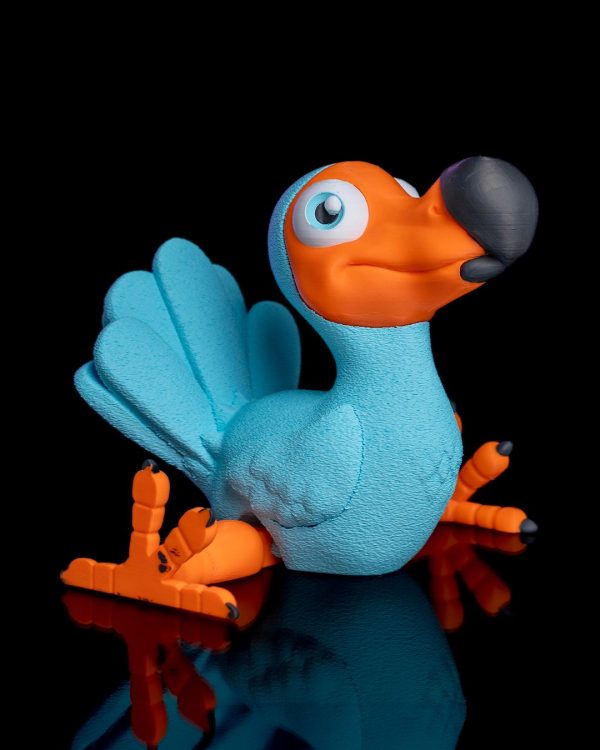 Blue and orange dodo bird figurine with big eyes on a black background.