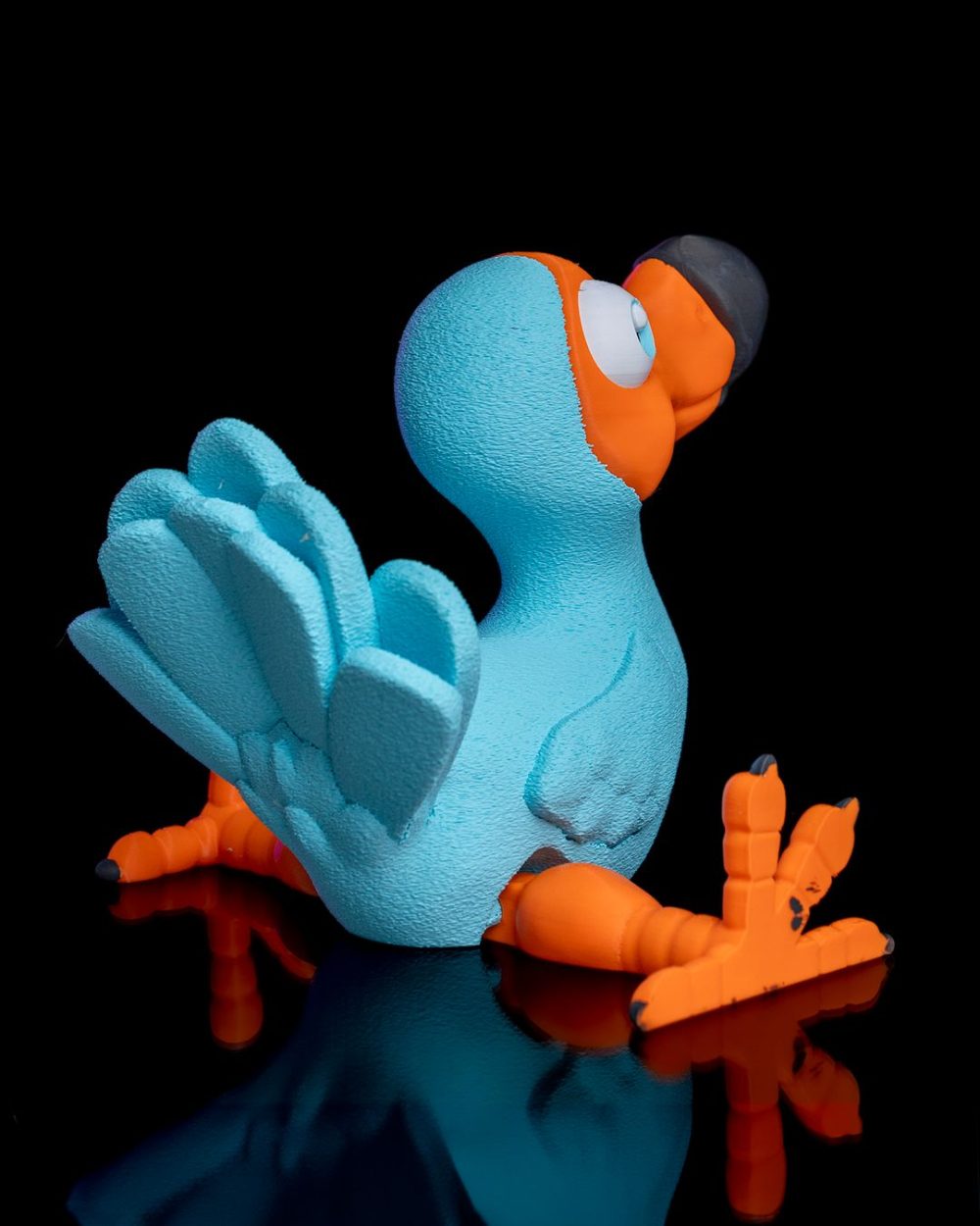 Articulated Dodo Bird – Custom – 3D Printed – Figure in blue and orange, displayed on a black background.