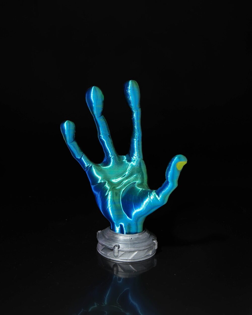 4-Finger Alien Hand Controller Holder in green and blue with a metallic base against a black background.