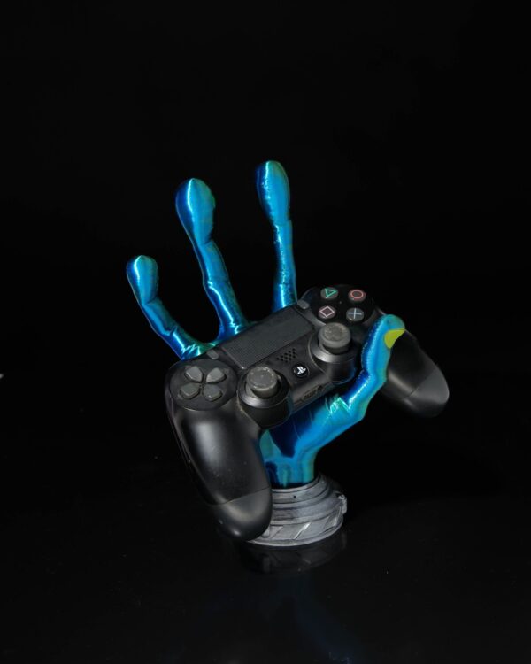 4-Finger Alien Hand Controller Holder in blue and green hues, gripping a black game controller against a dark background.