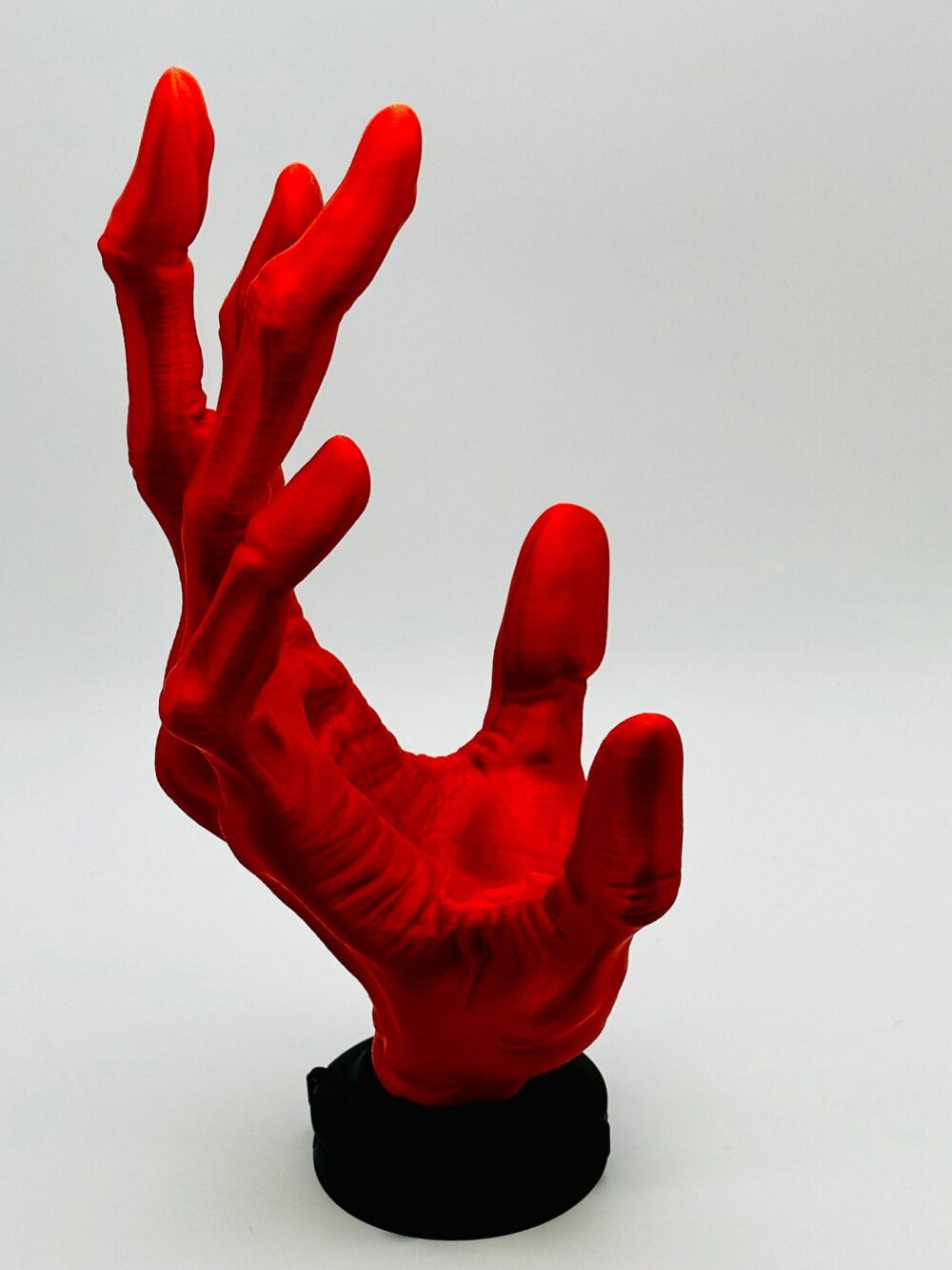 6-finger alien hand controller holder, vibrant red with elongated fingers designed to securely grip and display gaming controllers.