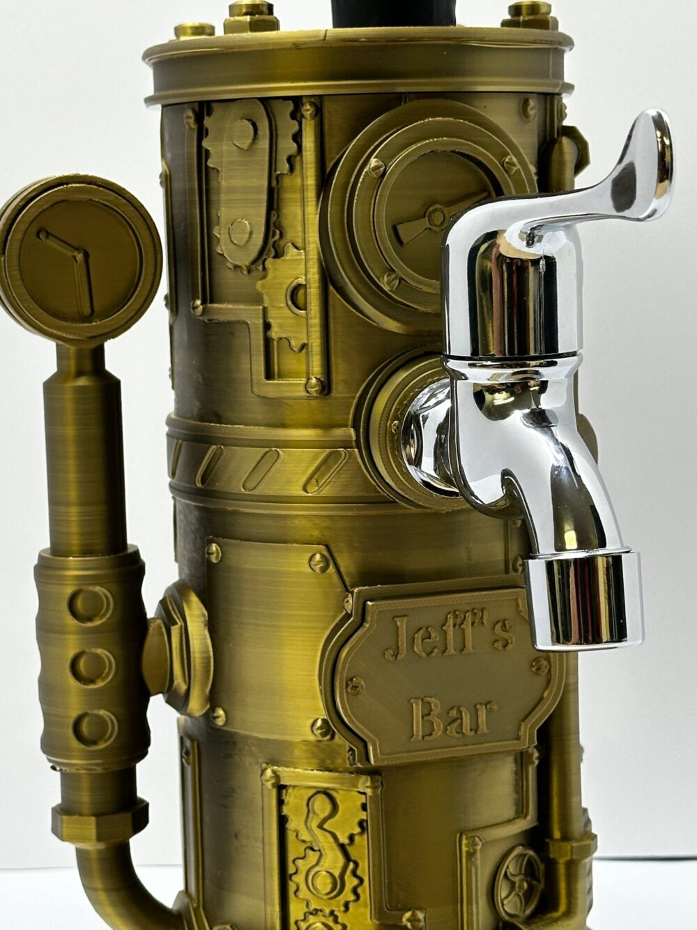 Steampunk Drink Dispenser with brass finish and gear details, featuring a chrome tap; the inscription reads "Jeff's Bar".