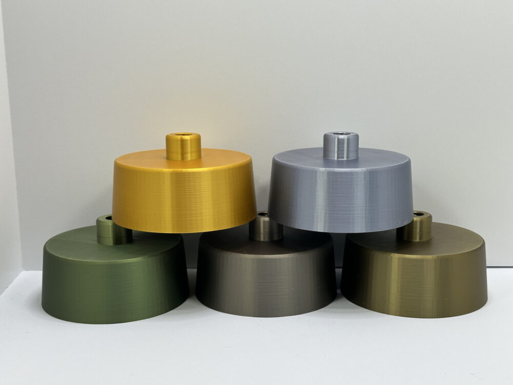 Base options for The Wavy Table Lamp: gold, silver, green, bronze, and brass finishes displayed against a neutral background.