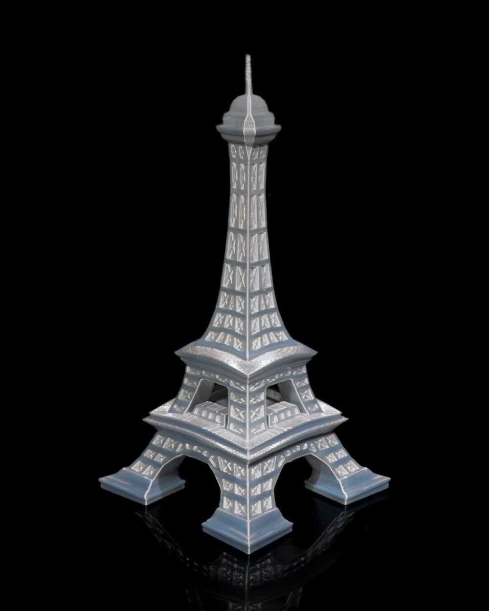 Eiffel Tower home decor model on a black background, ideal for living rooms, offices, or bedrooms. Parisian art sculpture in grey tones.