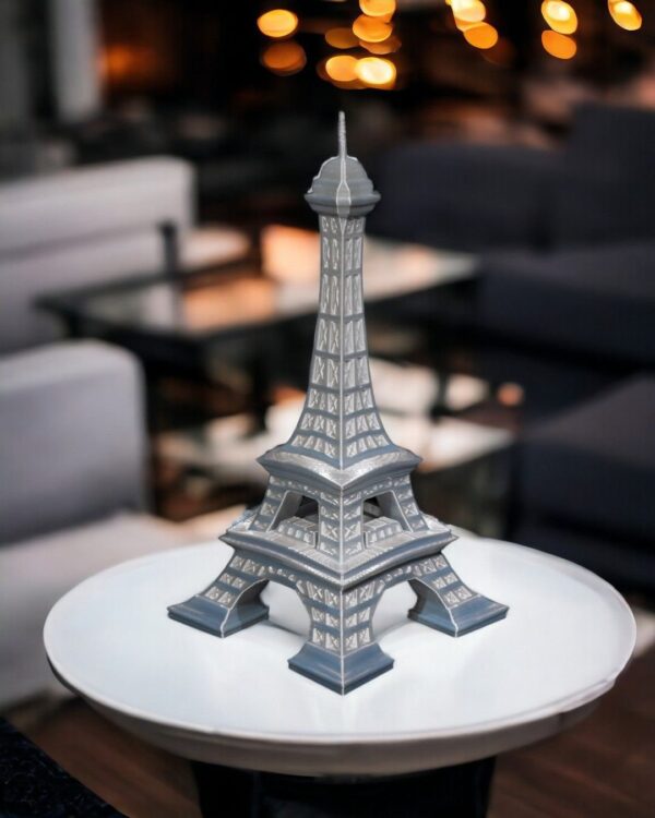 Eiffel Tower home decor model displayed on a small round table in a modern living room setting.